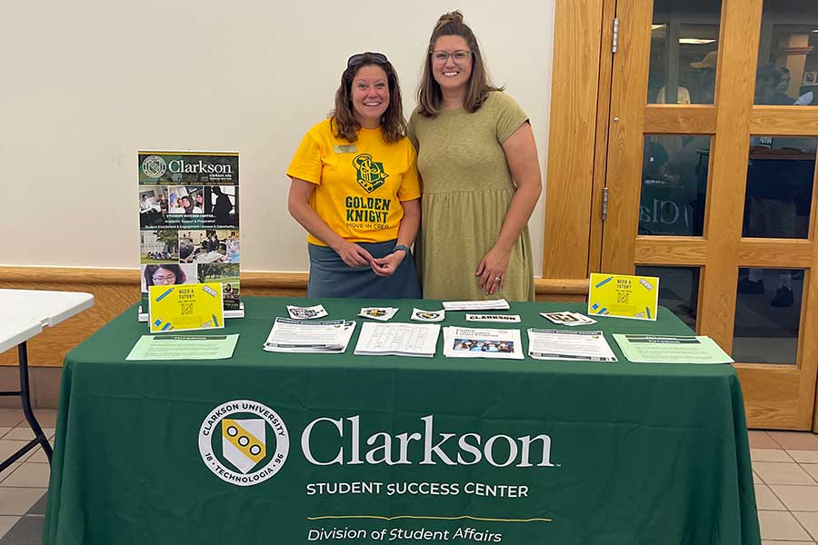 Employees from the student success center behind a table
