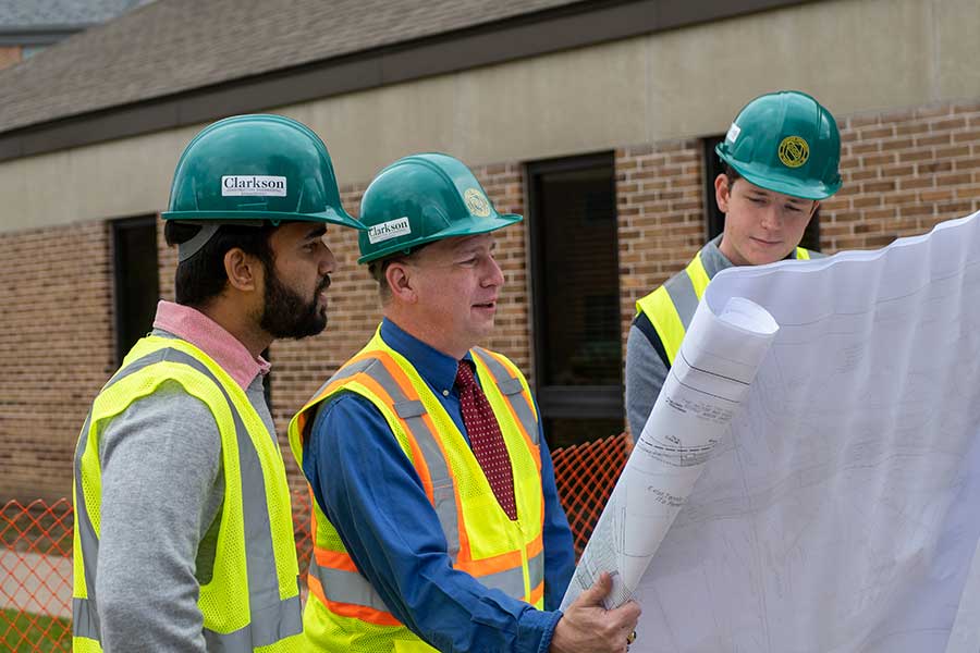 Students working with Professor Backus on a construction project