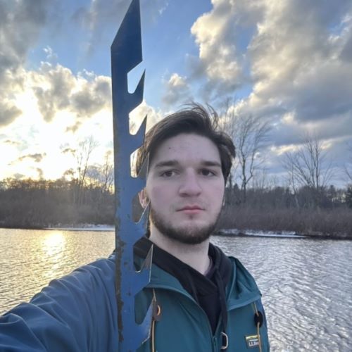 A photo of Mark Rampsperger in front of a river.