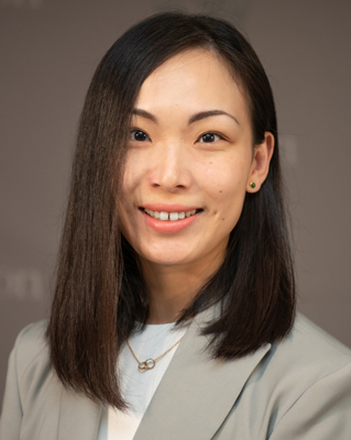 Shoulders-up portrait of Siwen Wang in gray jacket and white shirt