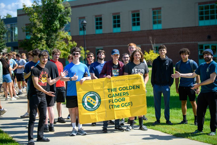 A photo of the fall 2024 golden gamers living learning community holding a banner