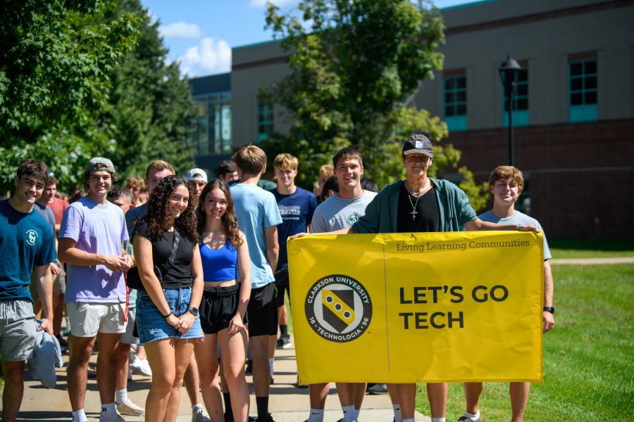 A photo of the Fall 2024 Lets go tech living learning community holding a banner