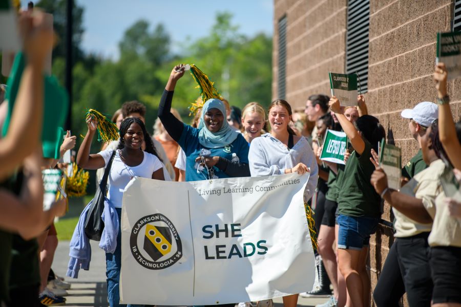 A photo of the Fall 2024 She Leads living learning community holding a banner