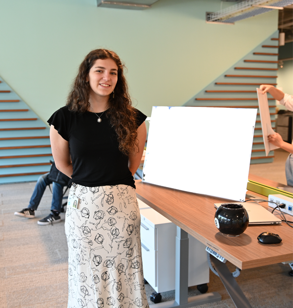 Gabriella posed next to her work