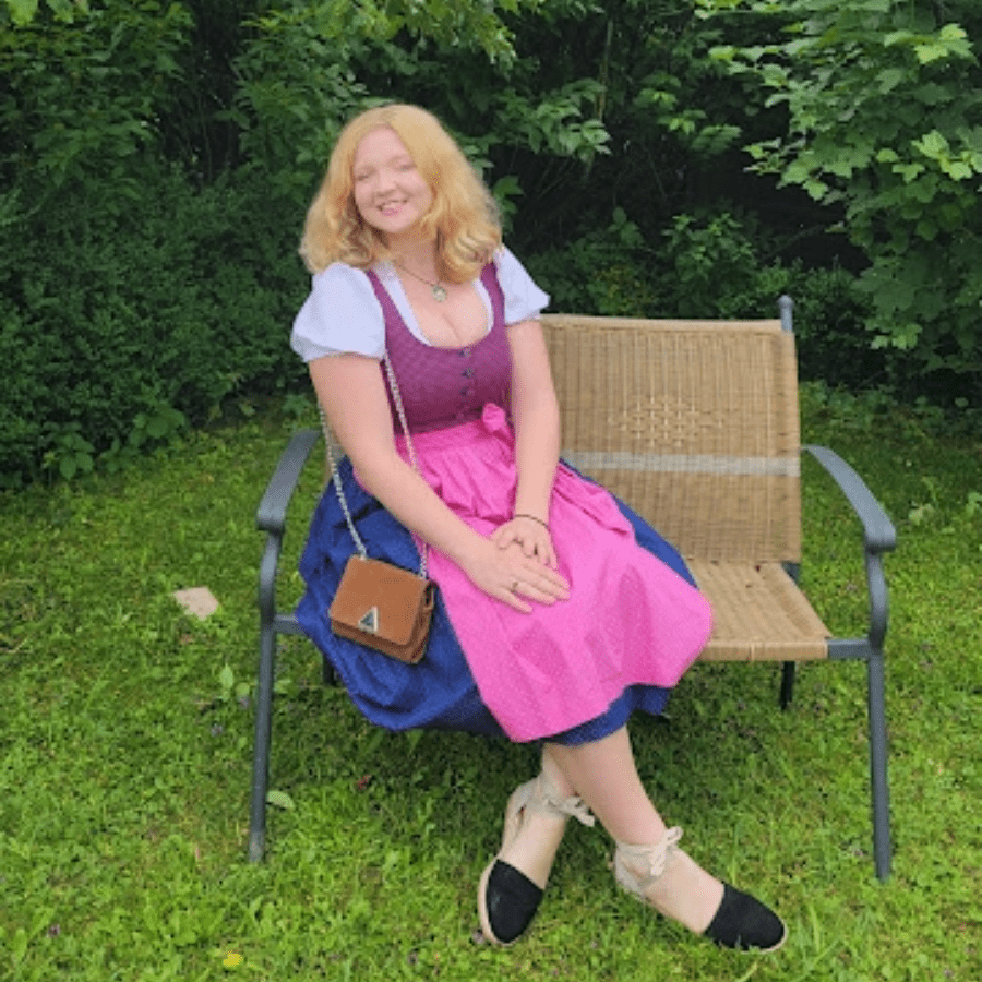 Lia cox sitting on a bench surrounded by nature