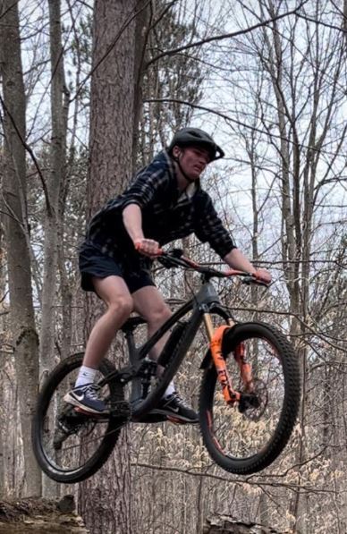 Male student on mountain bike.