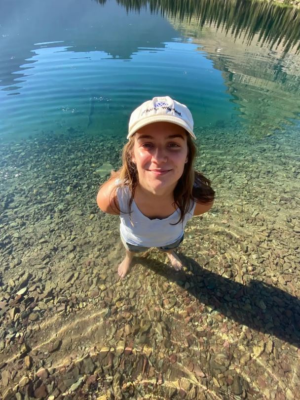 Emily King standing on a shoreline.
