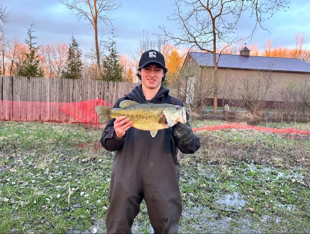 Male student holding a fish.