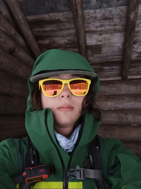 Male student with sunglasses and hiking gear