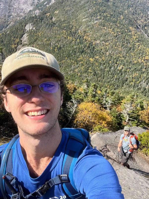 Male student hiking in the mountains.