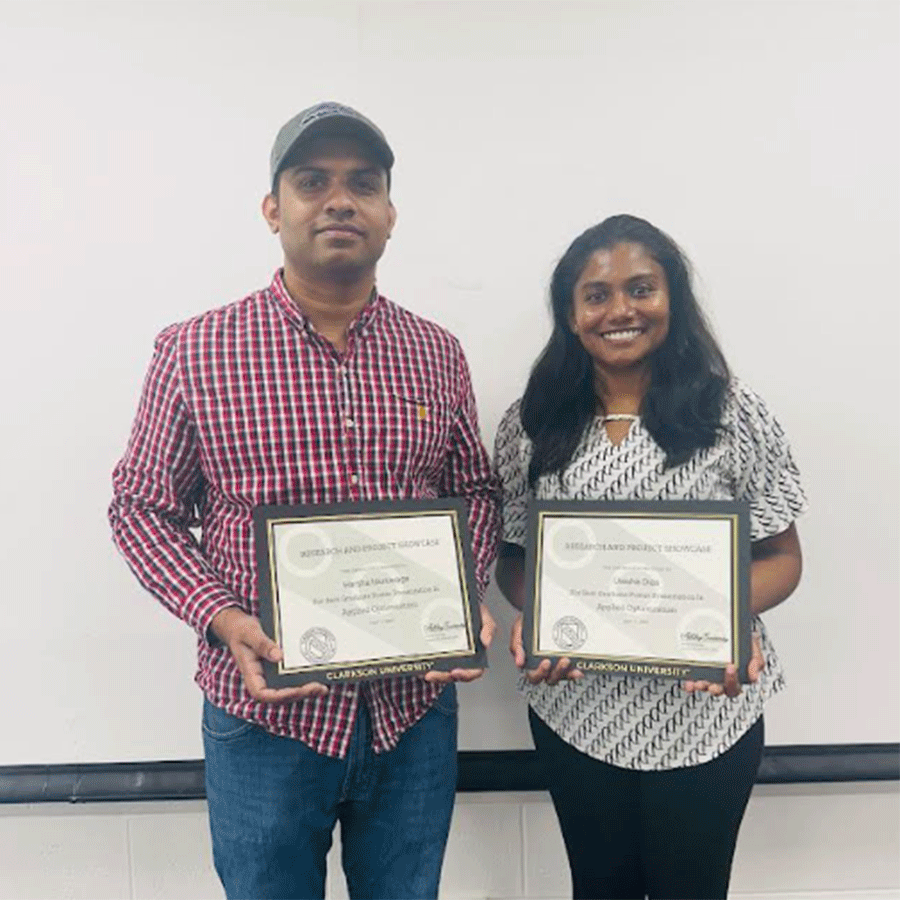 Graduate students Uresha Dias and Harsha Iduruwage from the mathematics department show off their award certificates