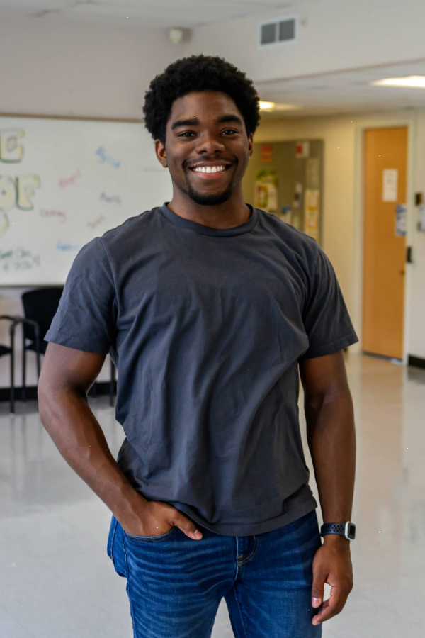 Headshot photo of Joshua Ashley, right hand in his pocket, left hand out of his pocket by his side