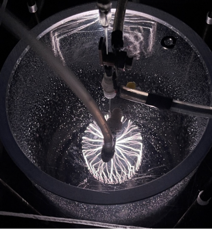 A plasma reaction taking place in a glass cylinder