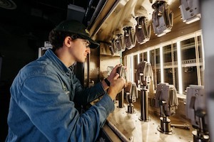 Student uses Clarkson University's multi station kappa machine.